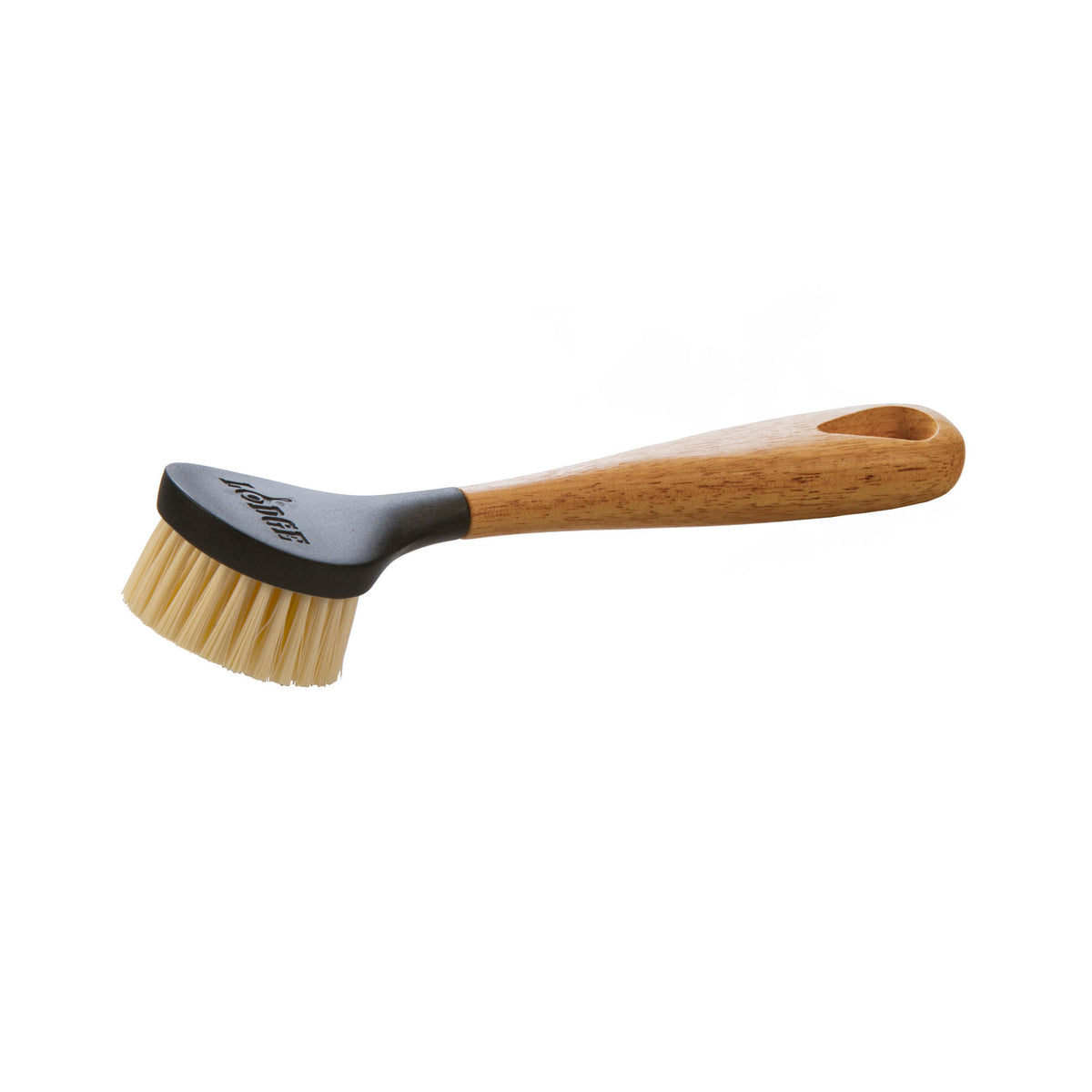 Brown LODGE brush with natural bristles, close-up view showing ergonomic handle and detailed bristle arrangement.