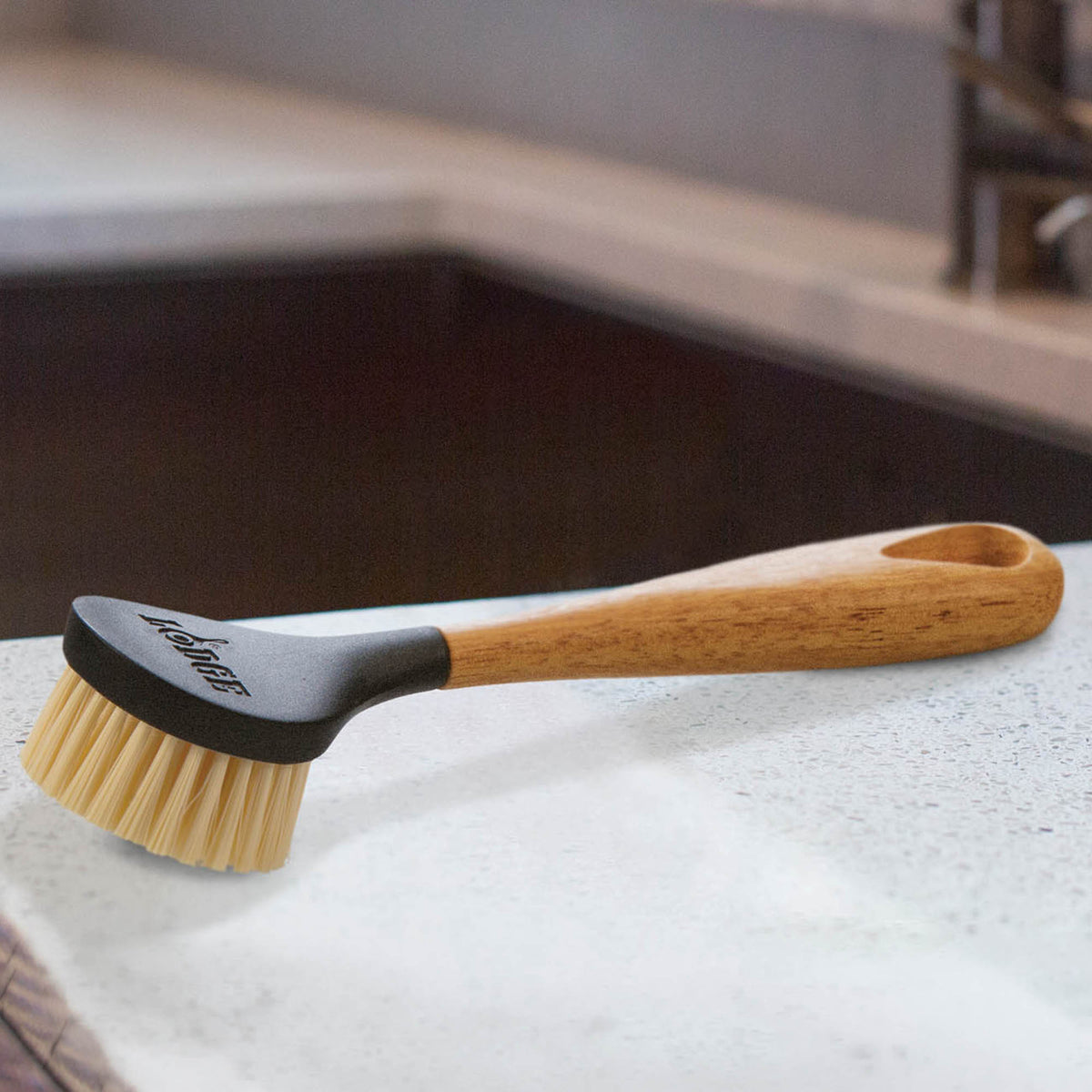 Brown Lodge brush with wooden handle and natural bristles, designed for grooming and styling hair.