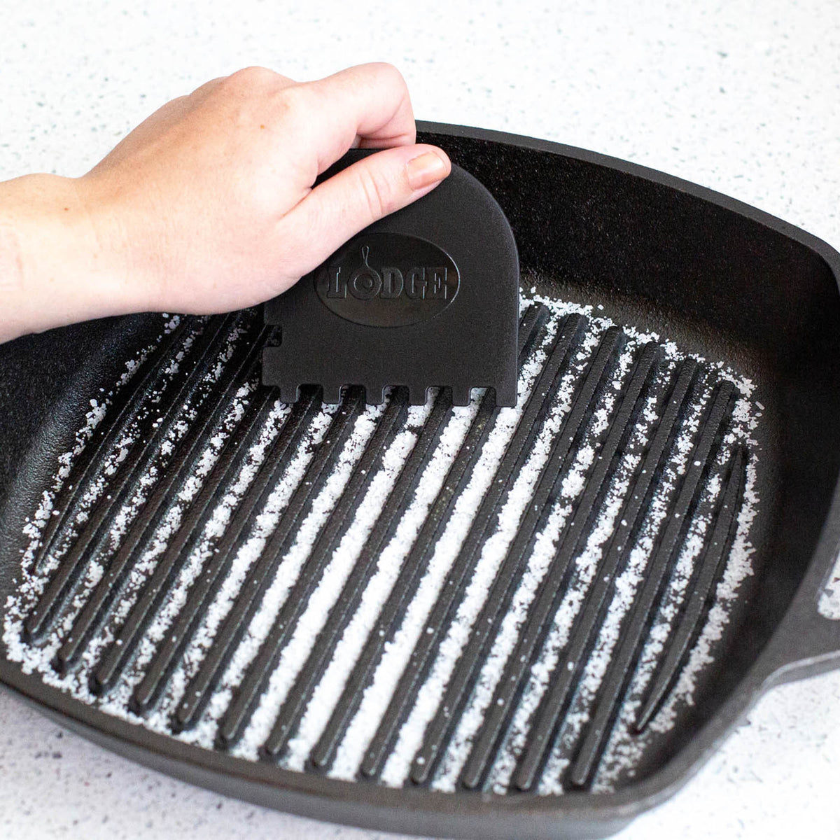 Lodge black and red grill pan scrapers, 2-piece set, with wooden handles for non-stick grill cookware cleaning.