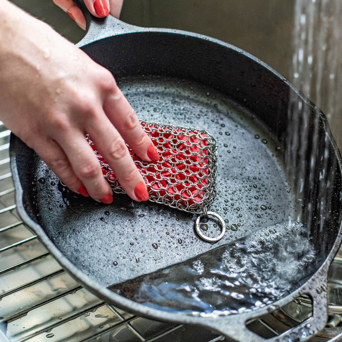 LODGE silicone and steel scrub pad in red, durable kitchen cleaning tool for cookware and surfaces.