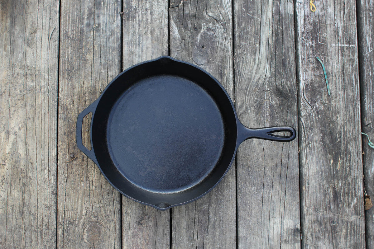 Black Lodge Classic cast iron skillet with handle, perfect for frying and cooking on stovetops or ovens.