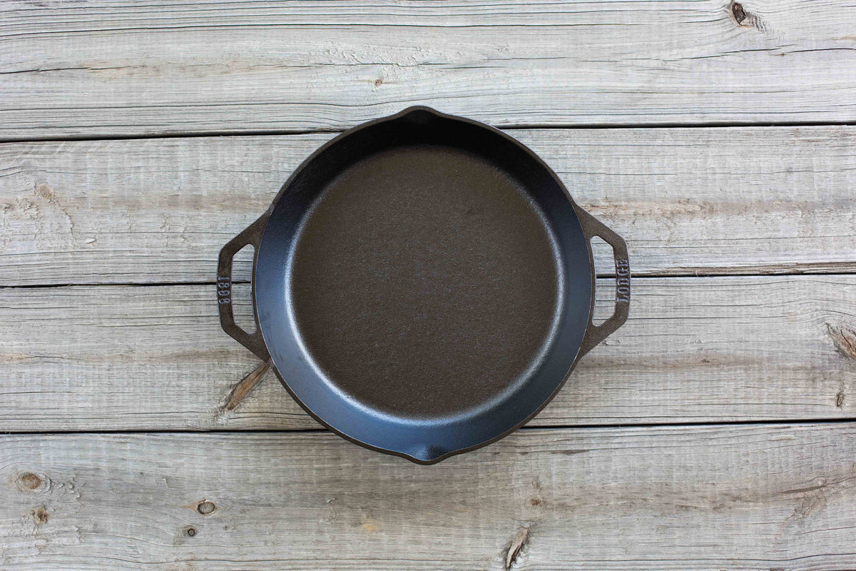 Lodge classic cast iron skillet in black, showing a sturdy, seasoned cooking pan with a handle and cooking surface.