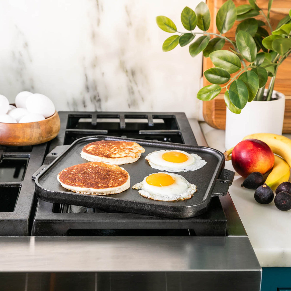 Lodge Classic black double-sided flat and ridged cast iron grill plate for versatile outdoor cooking.