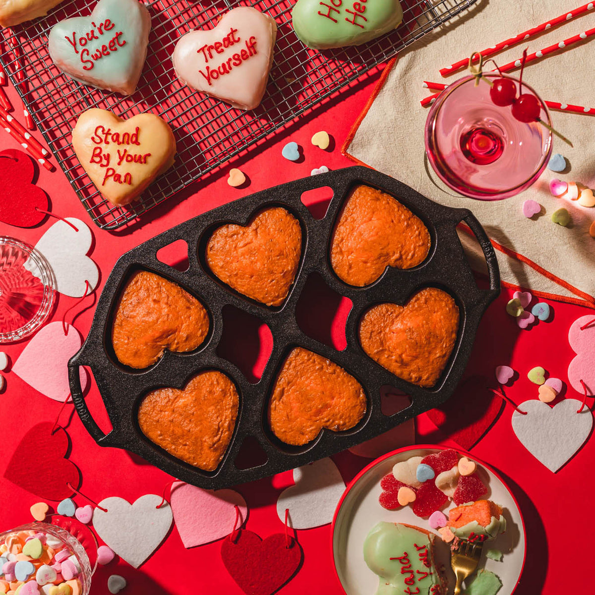 Lodge classic black 6-heart cake pan, durable bakeware for creating shaped cakes with detailed heart designs.