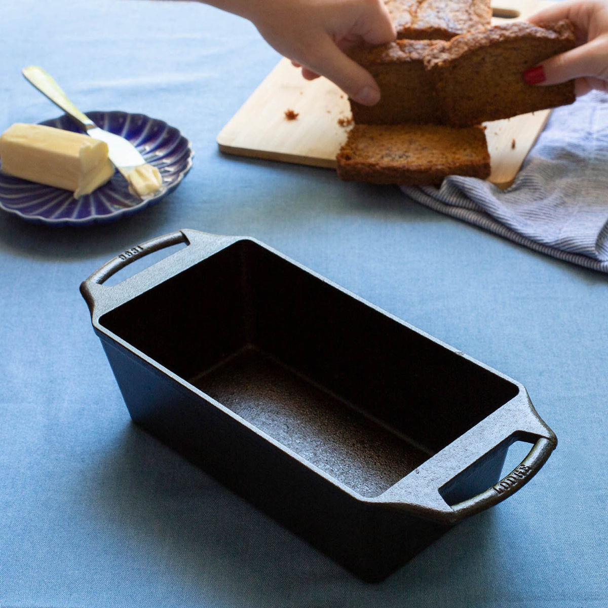 Black LODGE bread proofing basket, classic round Brotform with a woven pattern, for shaping homemade bread dough.