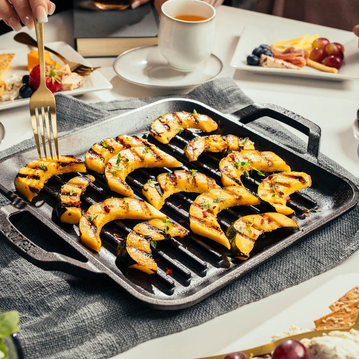 Lodge square cast iron grill pan with handle, 27.9 cm, ideal for grilling and searing on stovetop or grill.