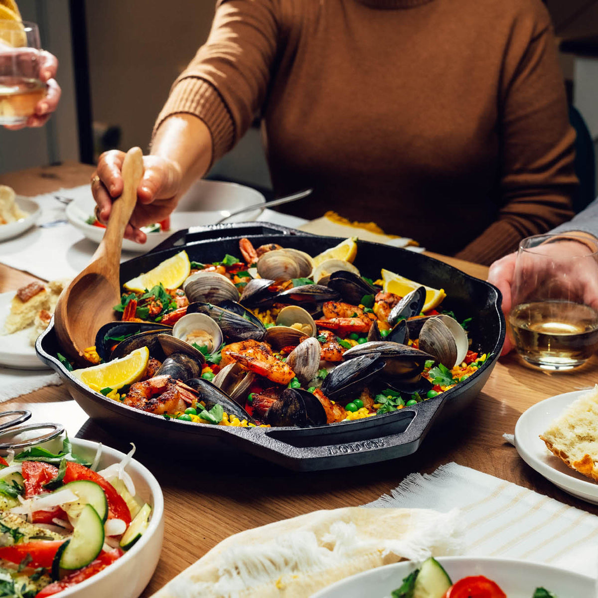 Lodge cast iron double handle skillet with chef's style, 35.6 cm diameter, used for versatile cooking and searing.