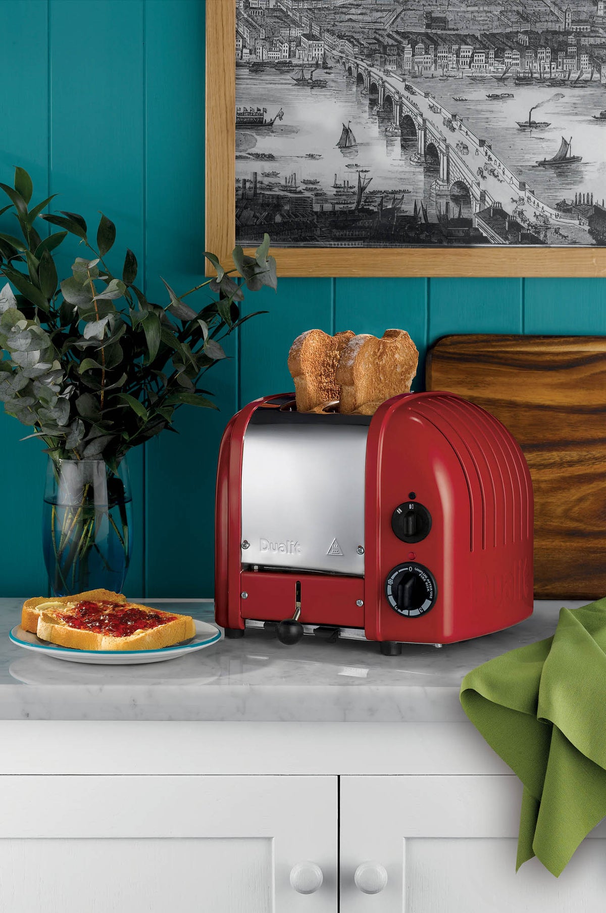 Polished DUALIT Newgen 2-slice toaster with sleek design and chrome finish, showing the toaster with bread slots open.
