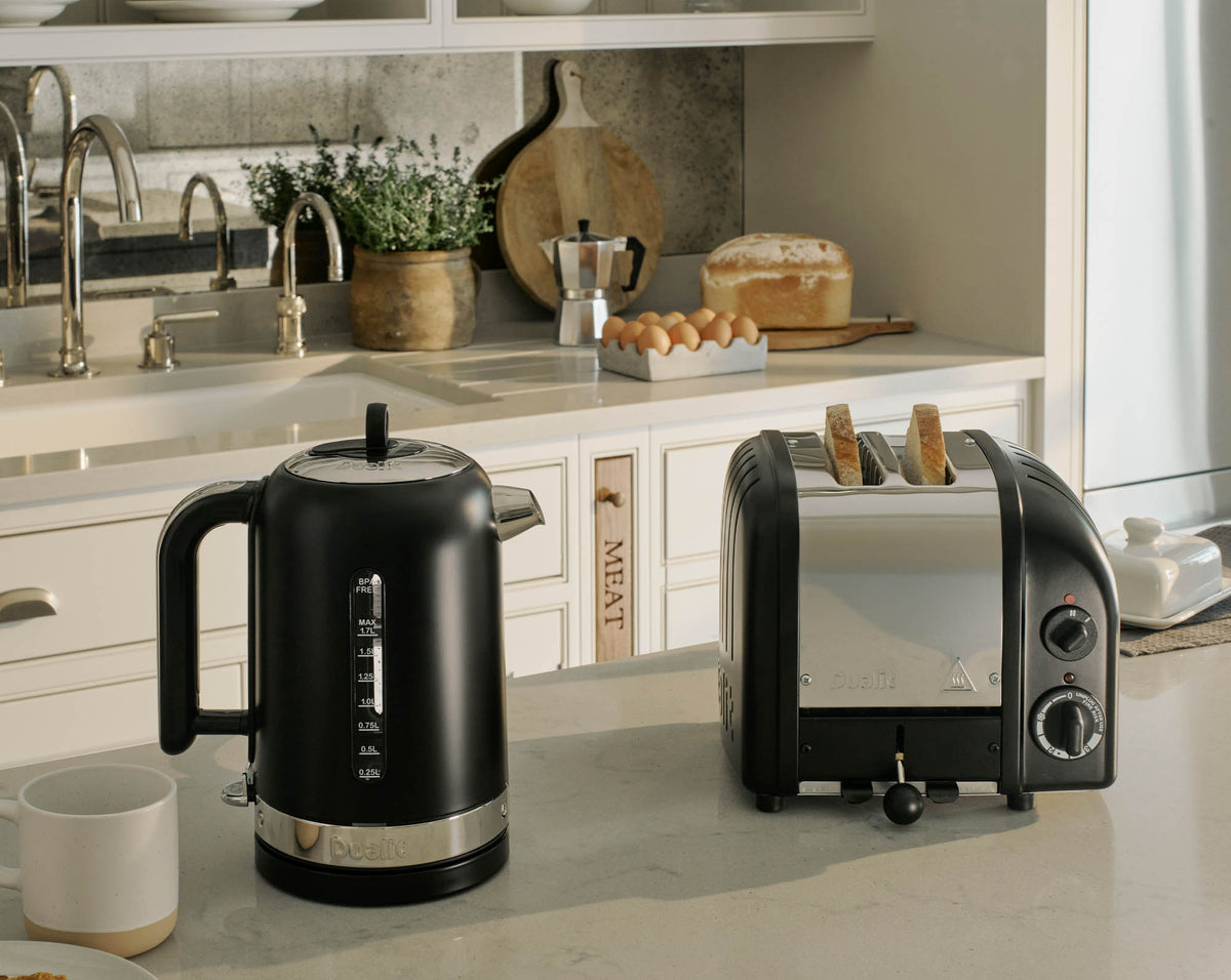 Dualit Newgen black 2-slice toaster with sleek design and control knobs, ideal for easy toasting.