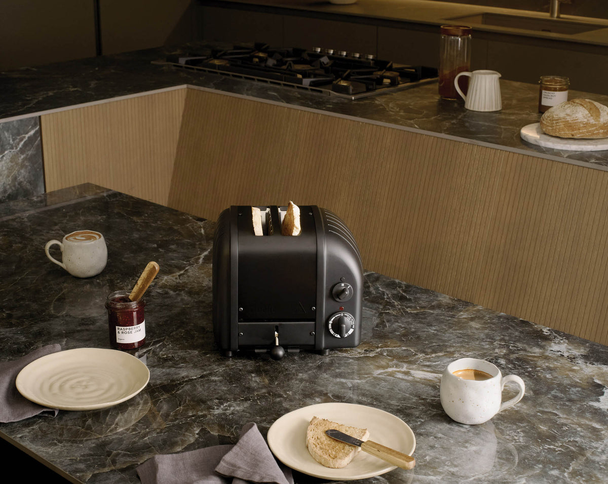 Dualit NewGen black 2-slice toaster with modern design and control buttons, perfect for quick, even toasting.