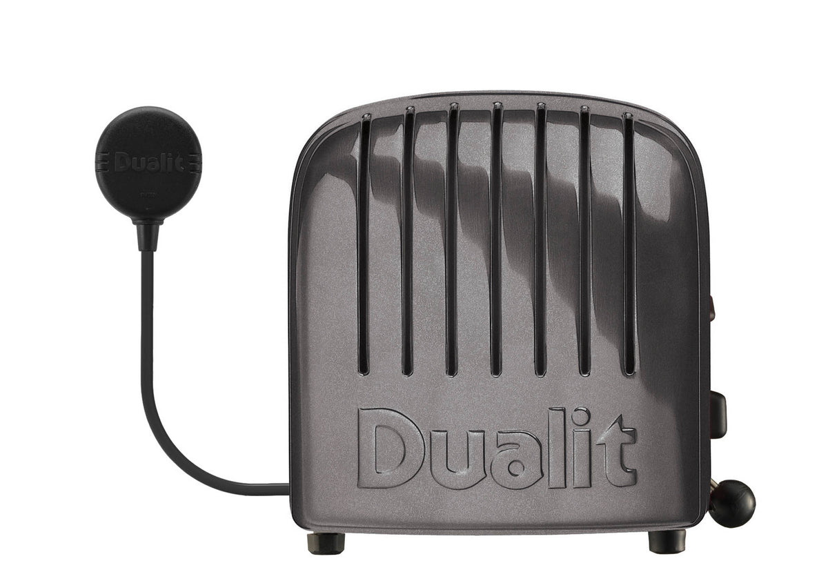 Dualit Newgen gray metallic 4-slice toaster with sleek design and modern finish, shown with bread slots open.