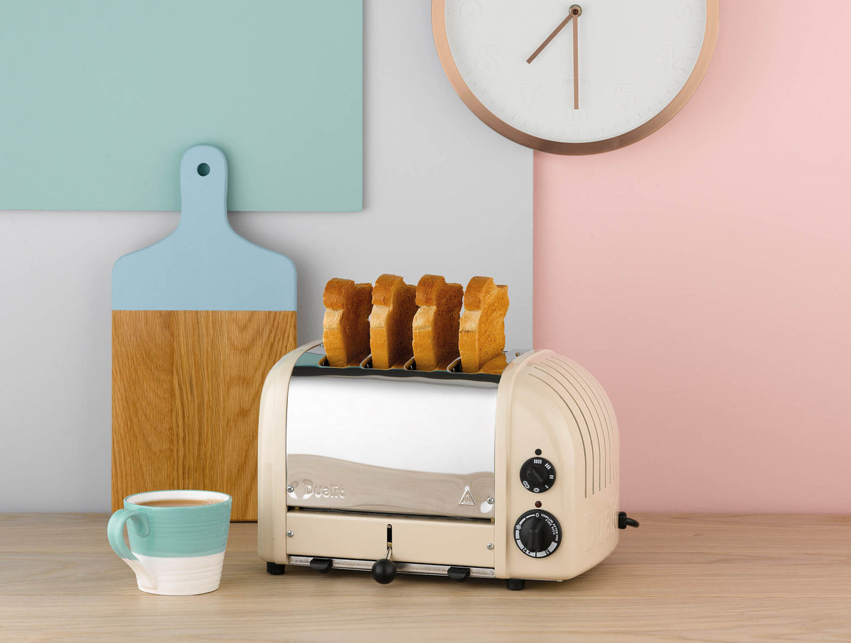 Dualit NewGen cream-white 4-slice toaster with modern design and control levers, perfect for toasting bread and bagels.