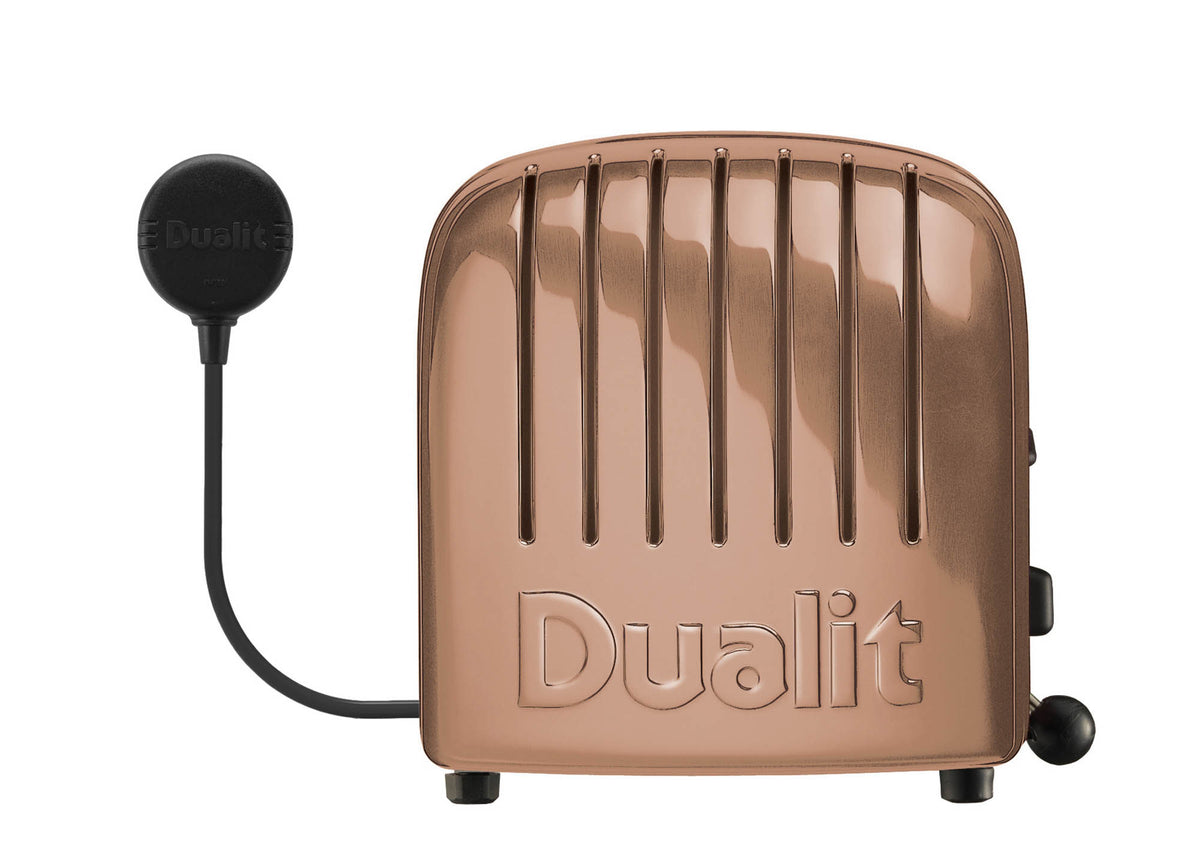 Dualit Newgen copper 4-slice toaster with modern design, featuring four slots for toasting bread and bagels.