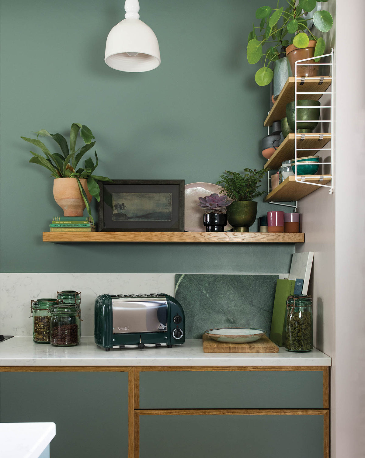 Dualit Newgen 4-slice evergreen toaster with modern design and control dials, perfect for toasting bread and bagels.
