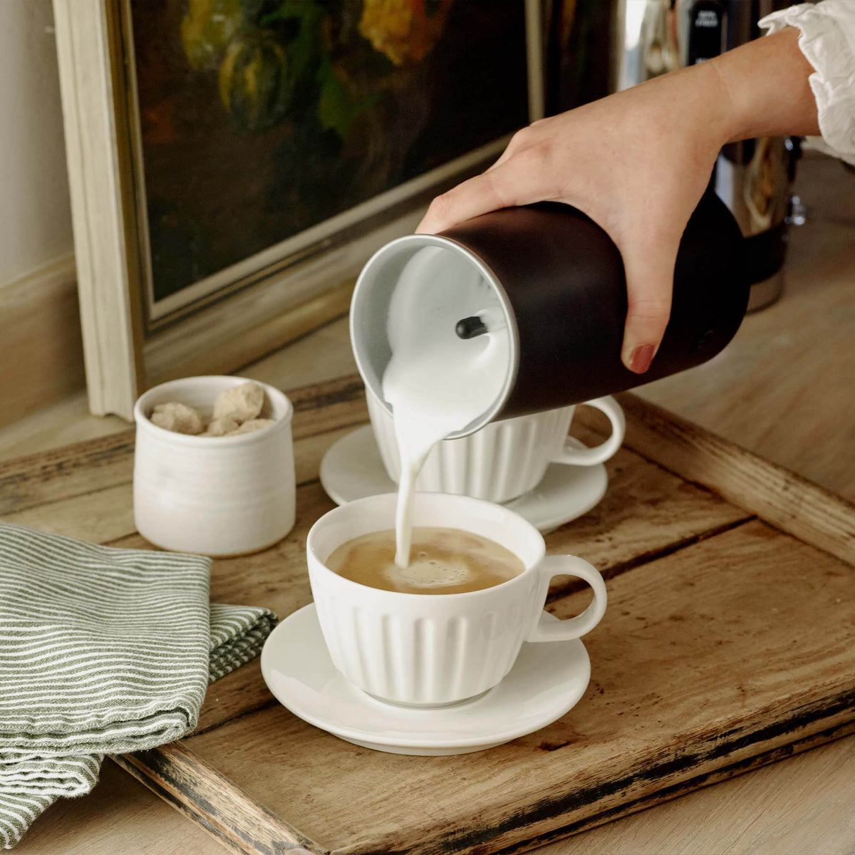 Dualit milk frother for milk and chocolate in black, compact electric milk steamer with whisk attachment.