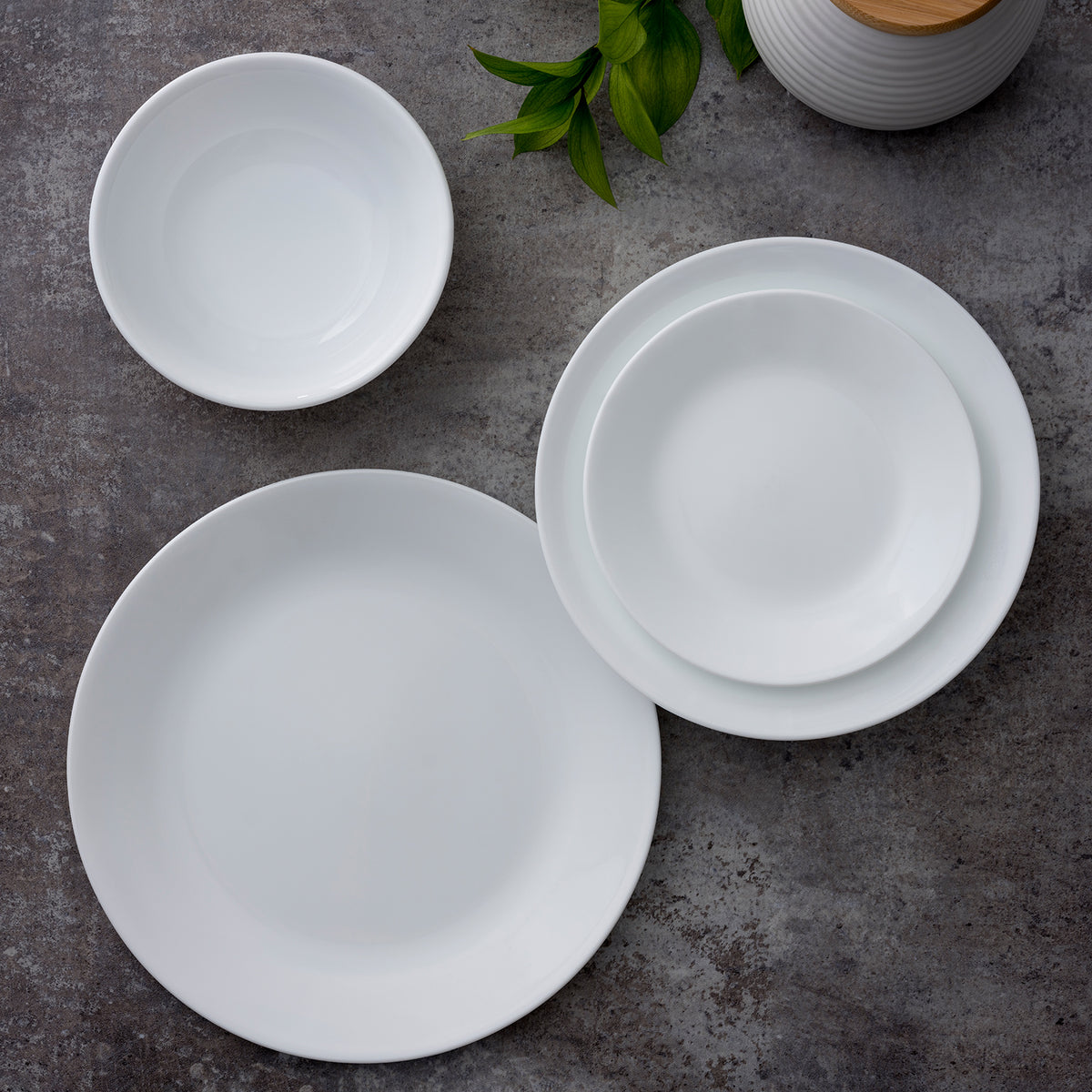 Corelle Winter Frost white dinner service with plates, bowls, and cups arranged on a table for elegant dining.