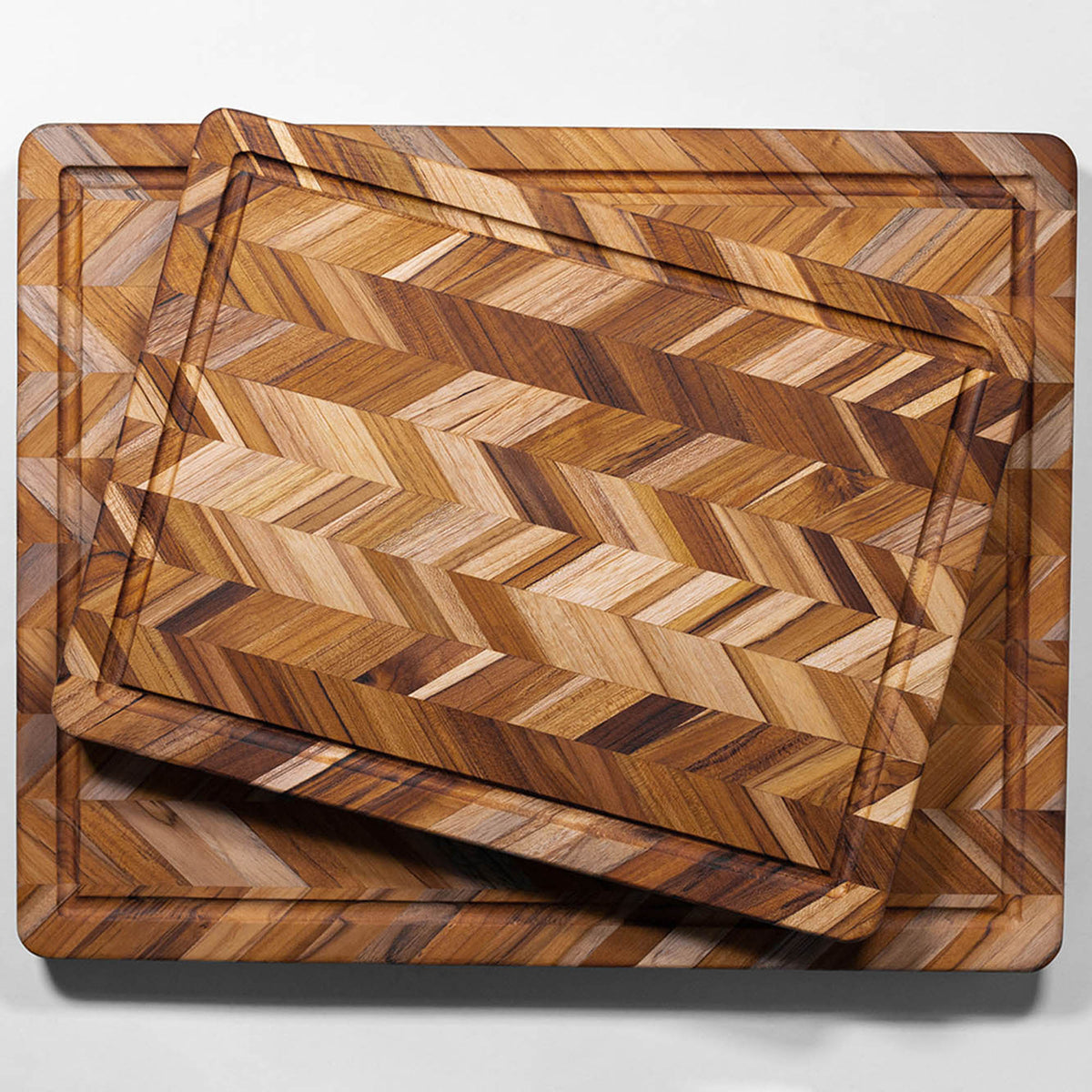 TEAKHAUS teak wood cutting board with herringbone pattern, ideal for kitchen prep and serving, made from durable teak wood.
