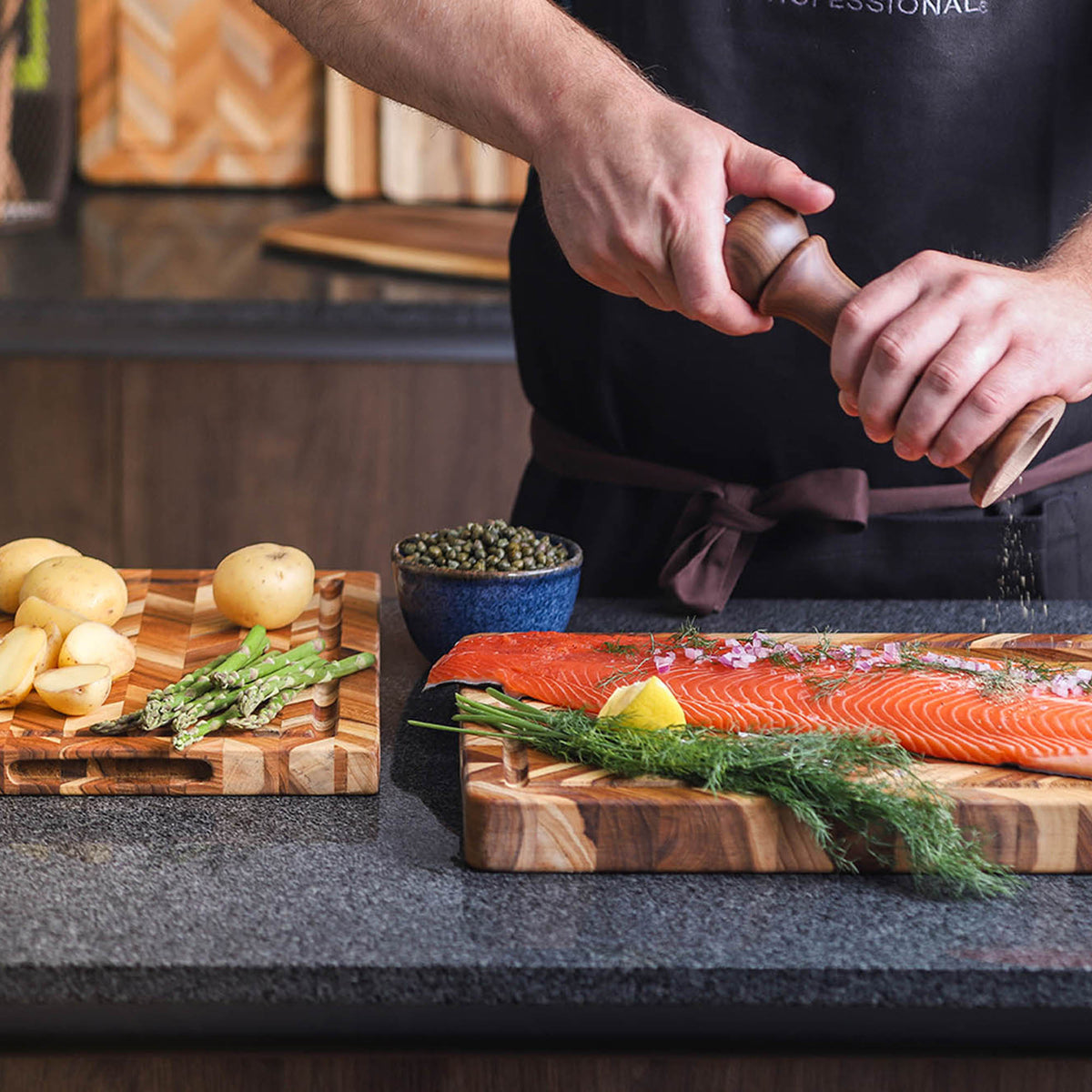 Teakhaus teak wood cutting board with herringbone pattern, ideal for kitchen prep and serving.