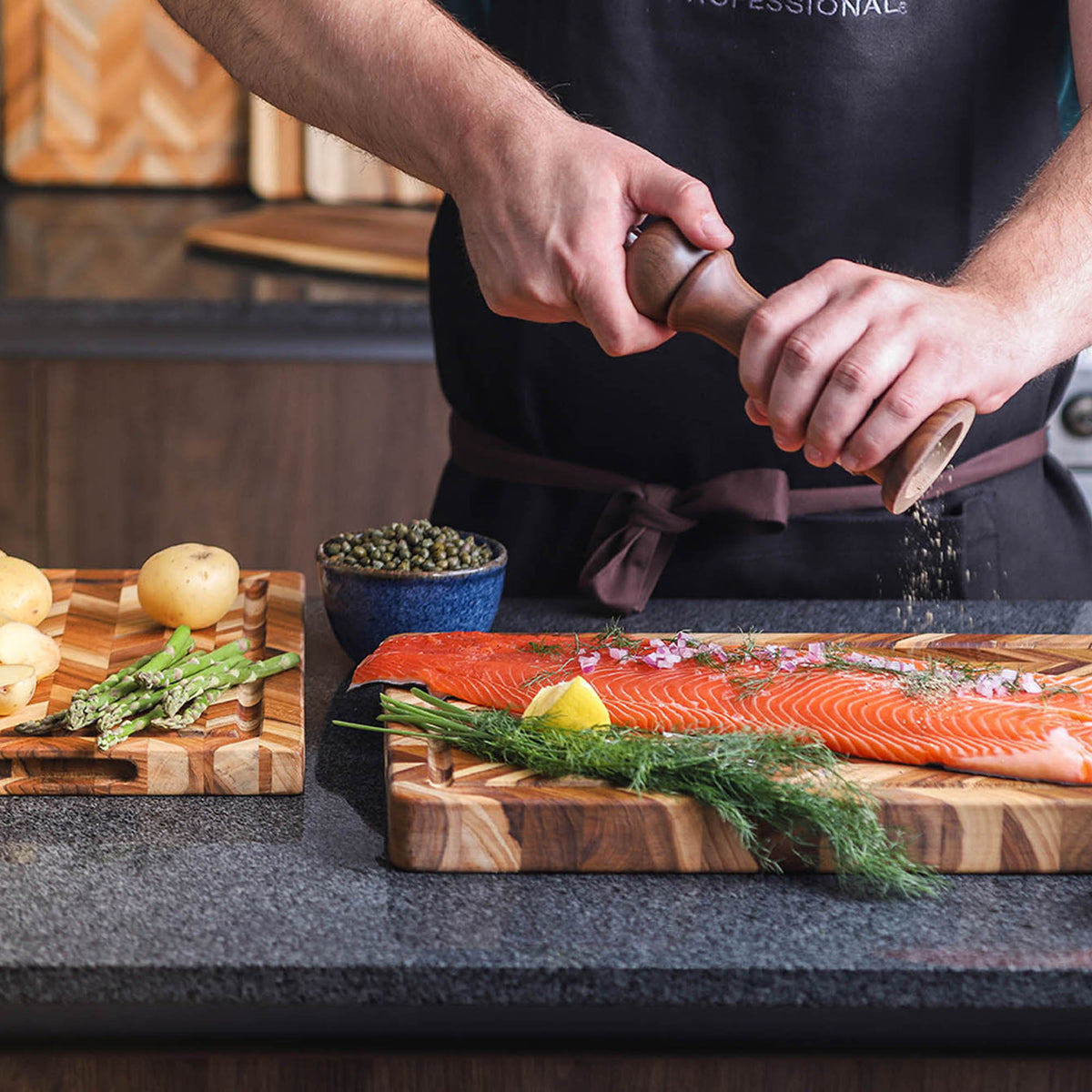TeakHAUS teak wood cutting board with herringbone pattern, ideal for kitchen prep and serving, made from durable teak wood.