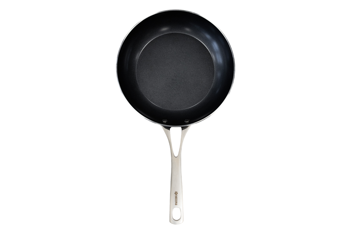 Kyocera ceramic frying pan in black with a smooth non-stick surface, ideal for versatile cooking.