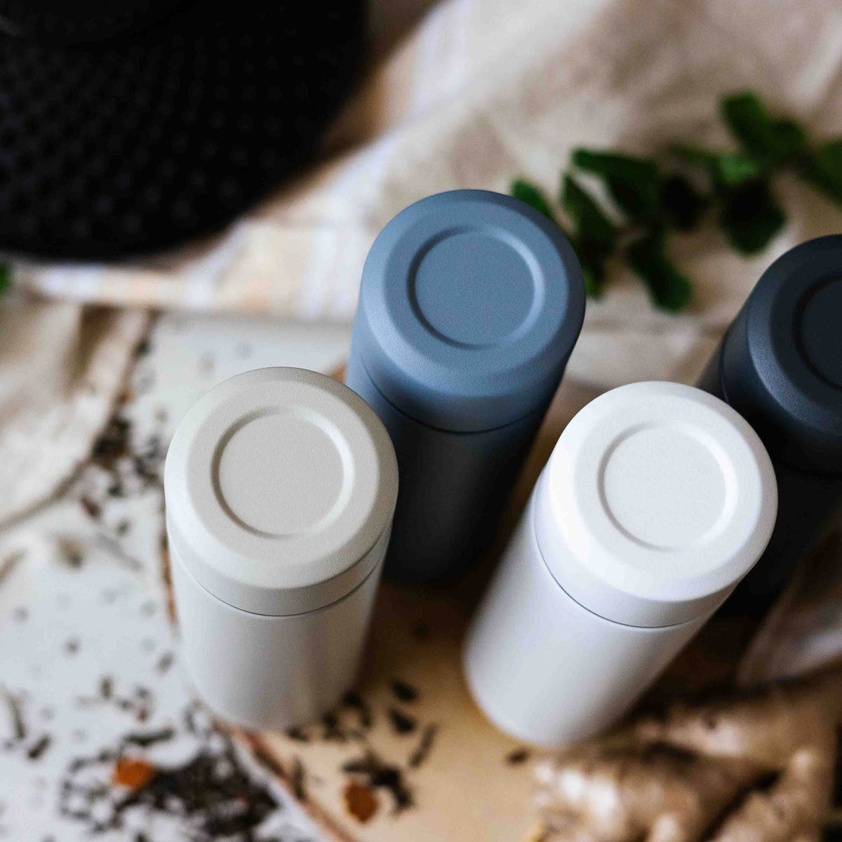 Blue KYOCERA Slim Mug insulated bottle with sleek design, stainless steel body, and secure lid for hot and cold beverages.