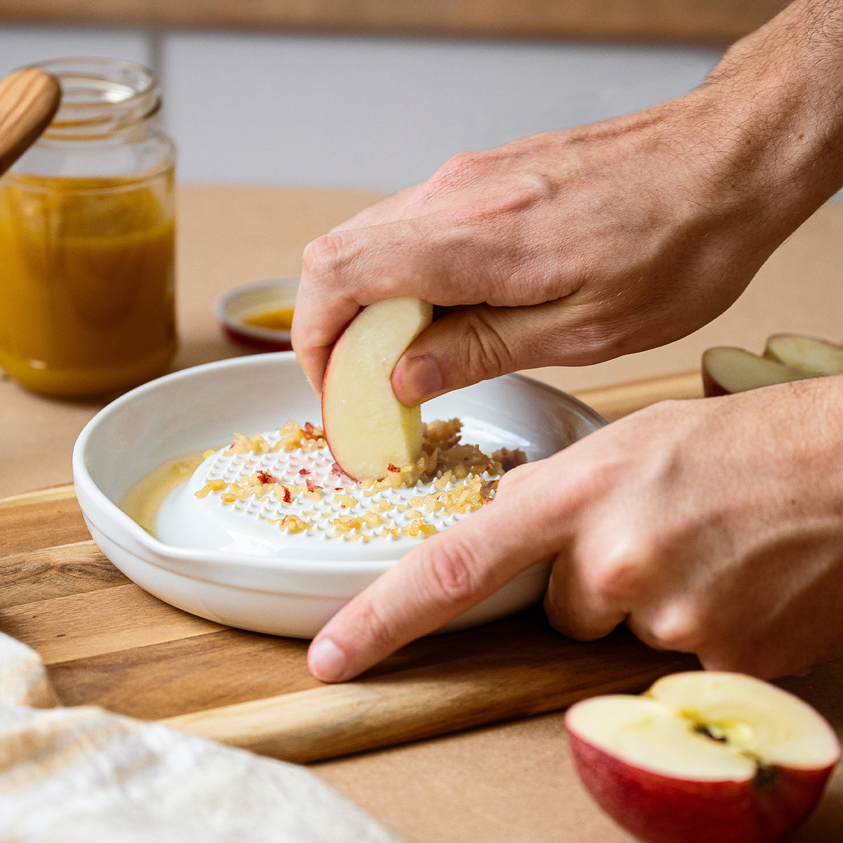 White KYOCERA ceramic grater with a sleek design, ideal for efficiently grating cheese, vegetables, and spices.