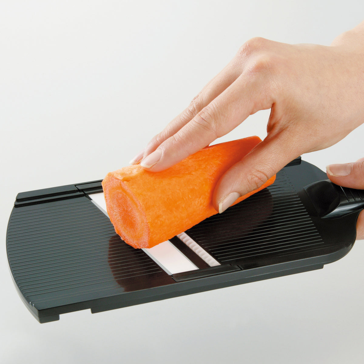 Kyocera julienne vegetable grater hobel in black, featuring sharp blades for precise julienne cuts.