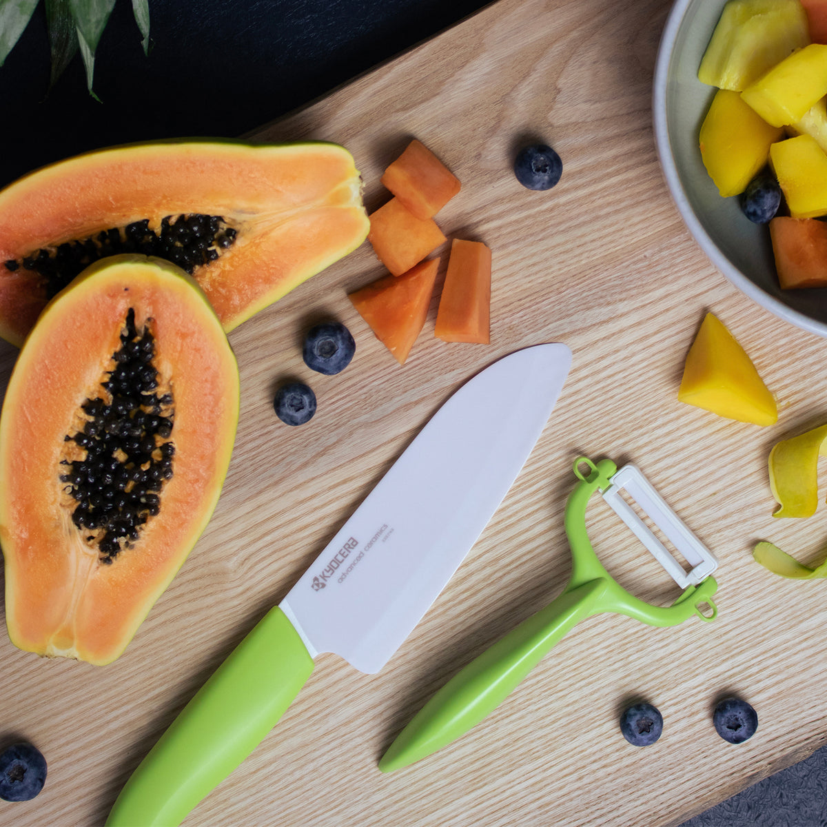 Kyocera double-sided green vegetable peeler with sharp dual blades for efficient peeling and easy kitchen use.