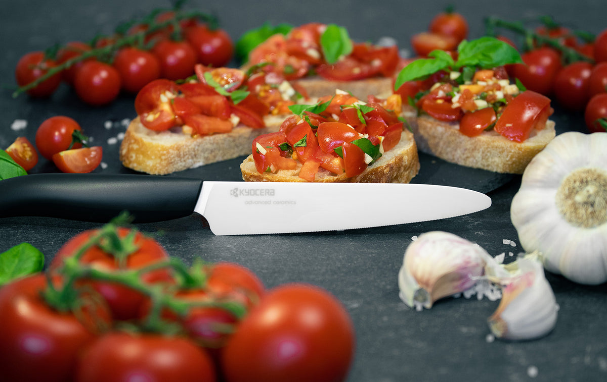 Black KYOCERA ceramic knife with a sleek handle, ideal for precise slicing and cutting in the kitchen.