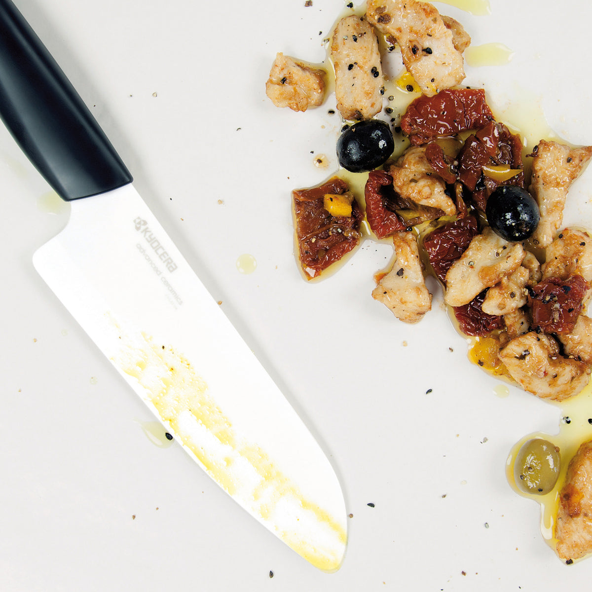 KYOCERA ceramic knife with black handle, GEN series, showcasing sharp blade for precise cutting.