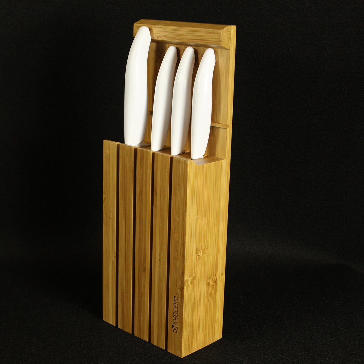 KYOCERA Messerblock with four GEN WHITE ceramic knives and bamboo stand, showcasing sleek kitchen knife storage.