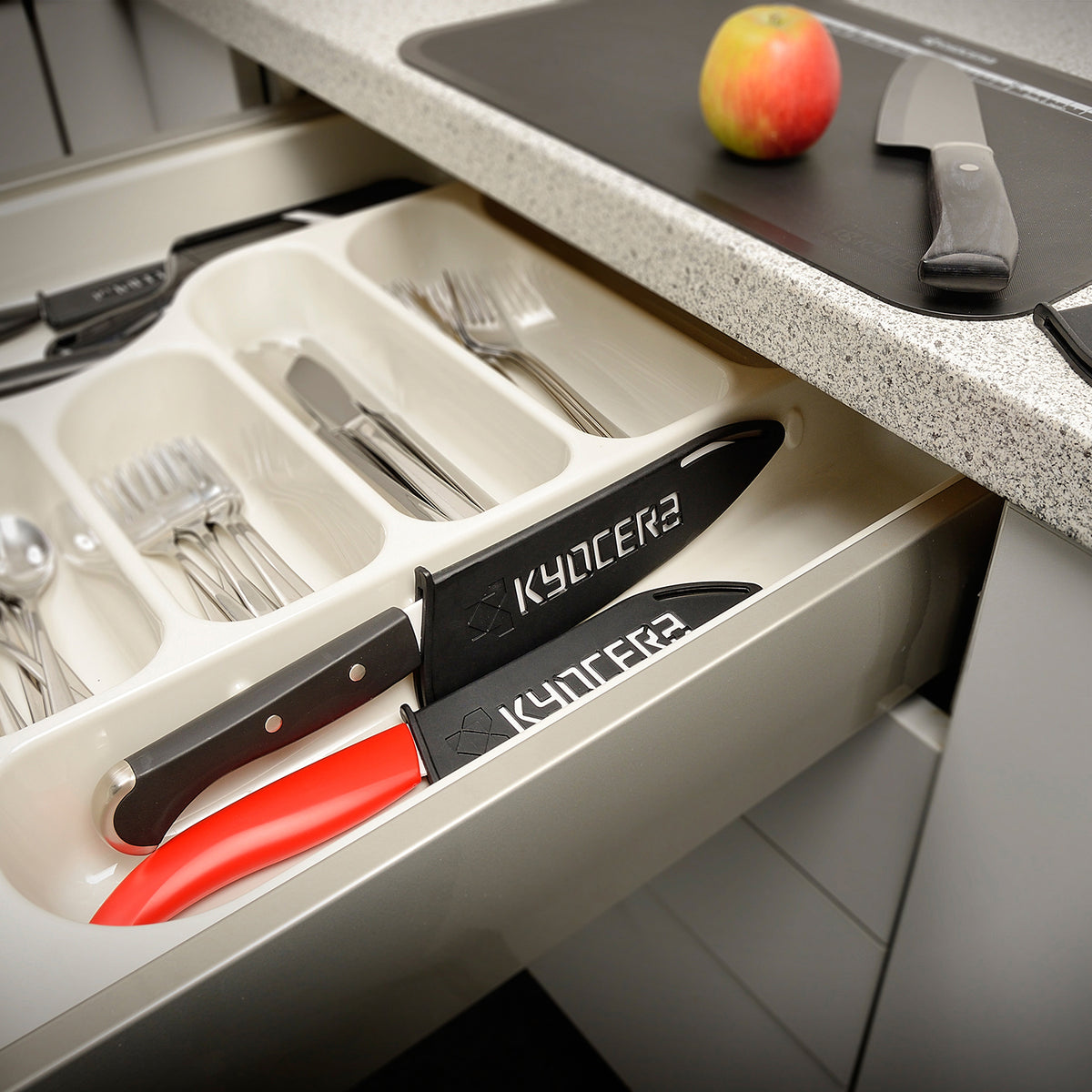 Black KYOCERA knife guard protecting blades up to 11 cm in length, made of durable material for safe storage.