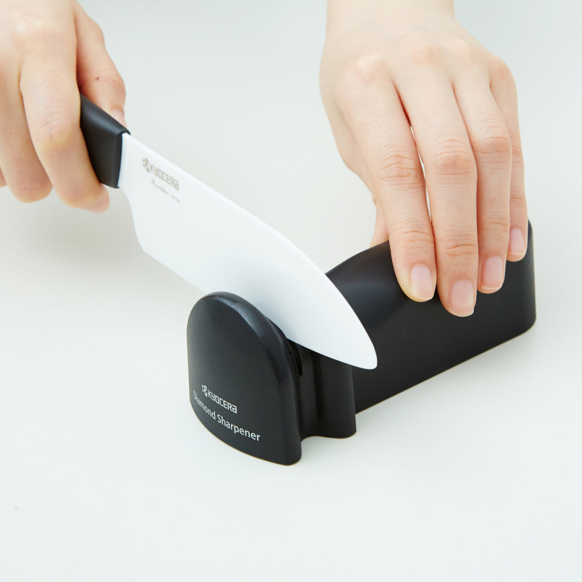KYOCERA ceramic and steel knife sharpener with ergonomic handle, designed for precision blade sharpening.