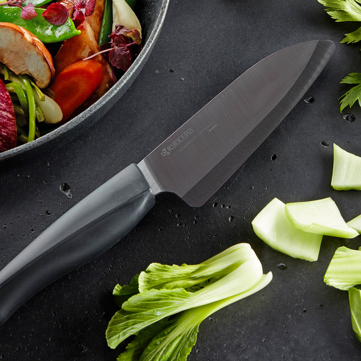 Kyocera SHIN black ceramic knife with sleek handle, perfect for precise slicing and cutting in the kitchen.