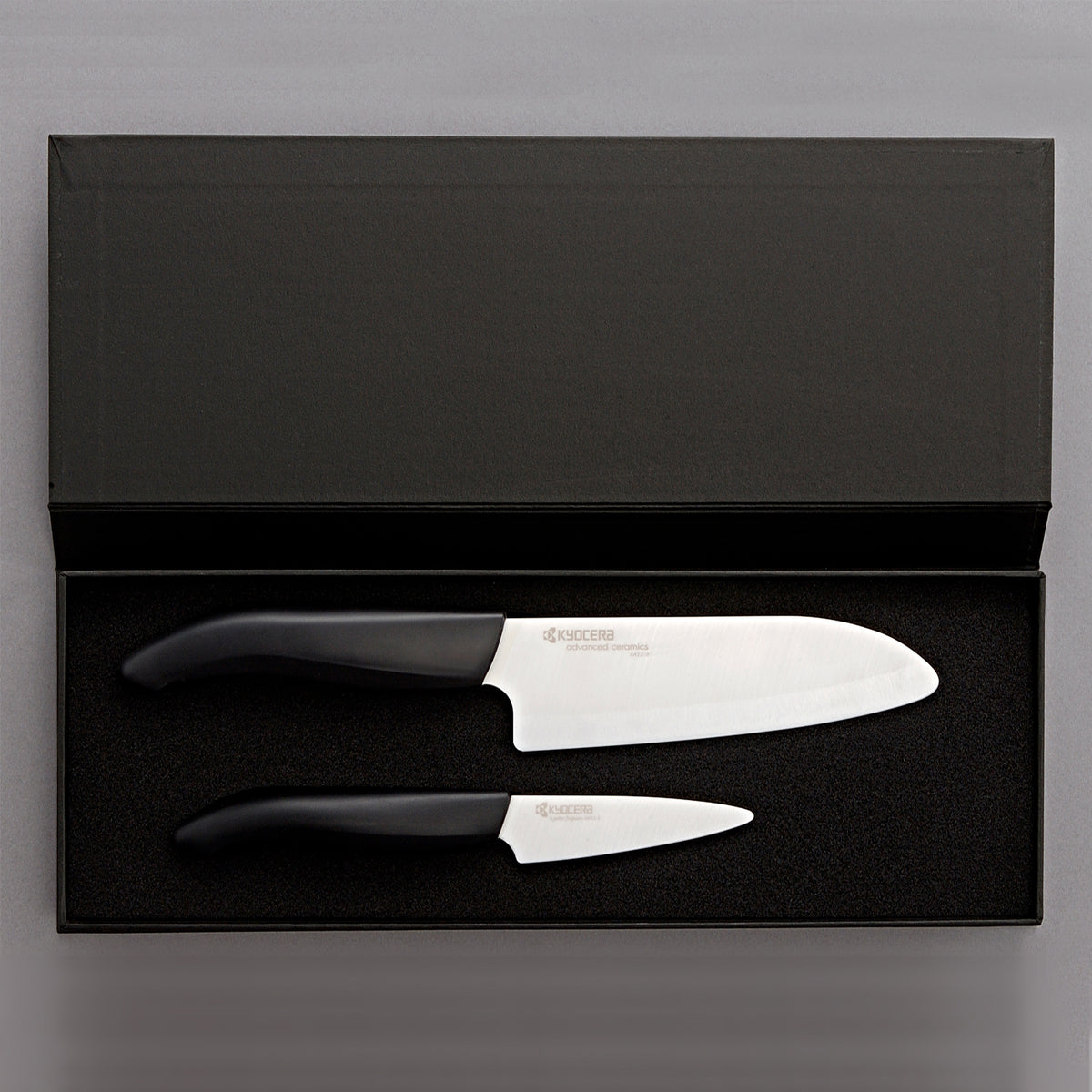 KYOCERA ceramic knife set with peeling and santoku knives, featuring sleek, sharp blades for precise kitchen cutting tasks.