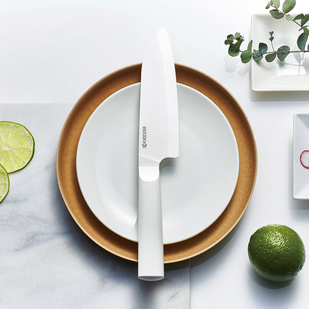 KYOCERA white ceramic knife with a sleek handle, ideal for precision cutting and kitchen prep.
