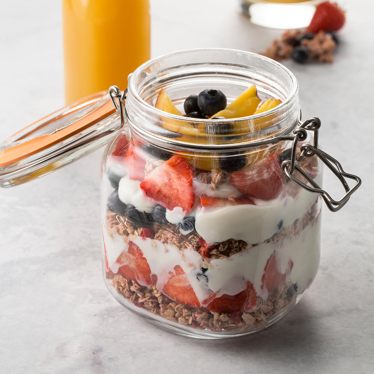 Clear KILNER Clip Square canning jar with metal clip lid, perfect for preserving fruits and vegetables.