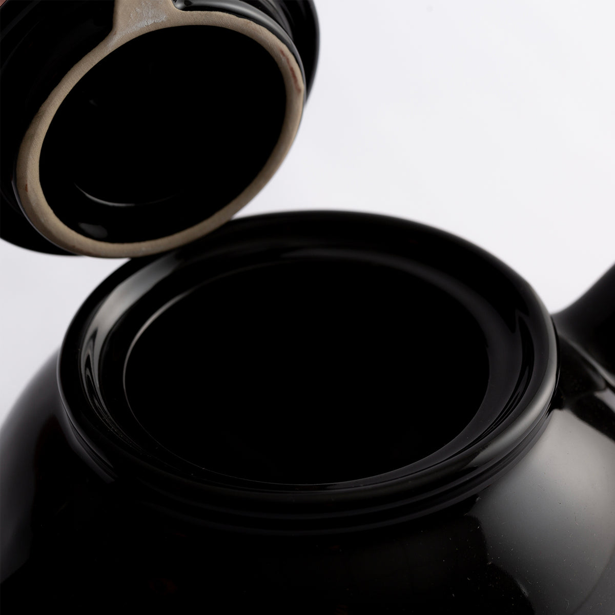 Black P & K Kensington teapot with a classic design, featuring a smooth handle and spout, against a plain background.