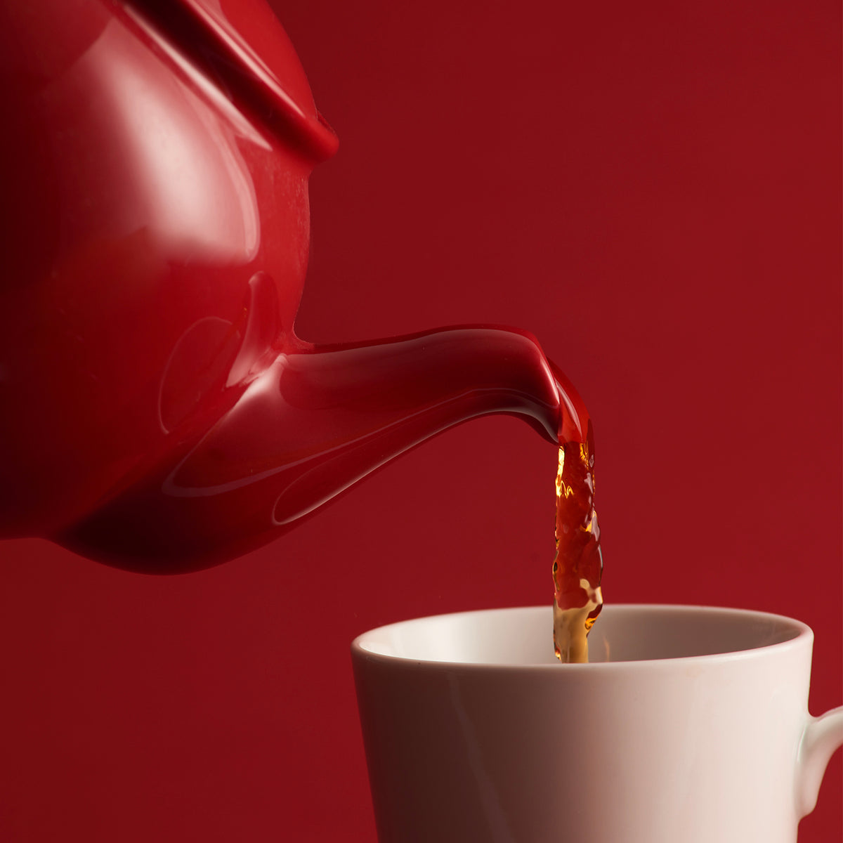 Red P & K Price & Kensington teapot with classic design and a rounded shape, shown from a side angle.