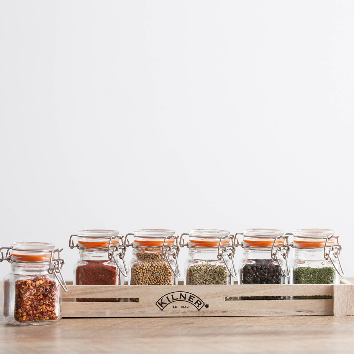 Clear Kilner Clip Square jar for preserving and storing food, featuring a secure clip lid and transparent glass body.
