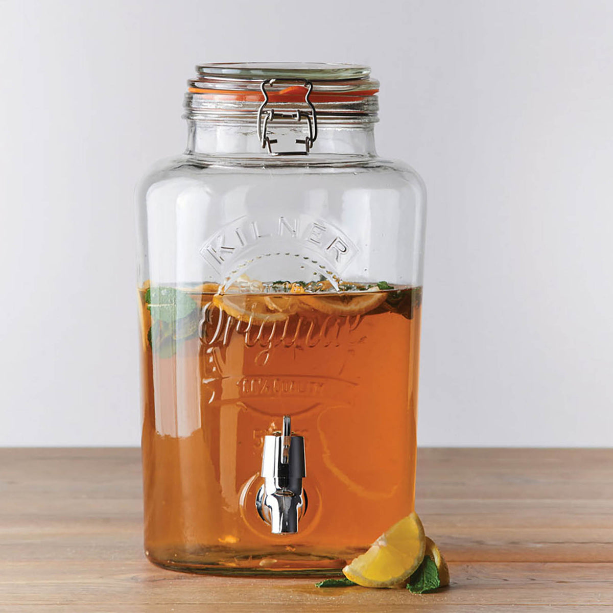 KILNER 5L clear round beverage dispenser with spigot for cold drinks and party serving, made of transparent glass.