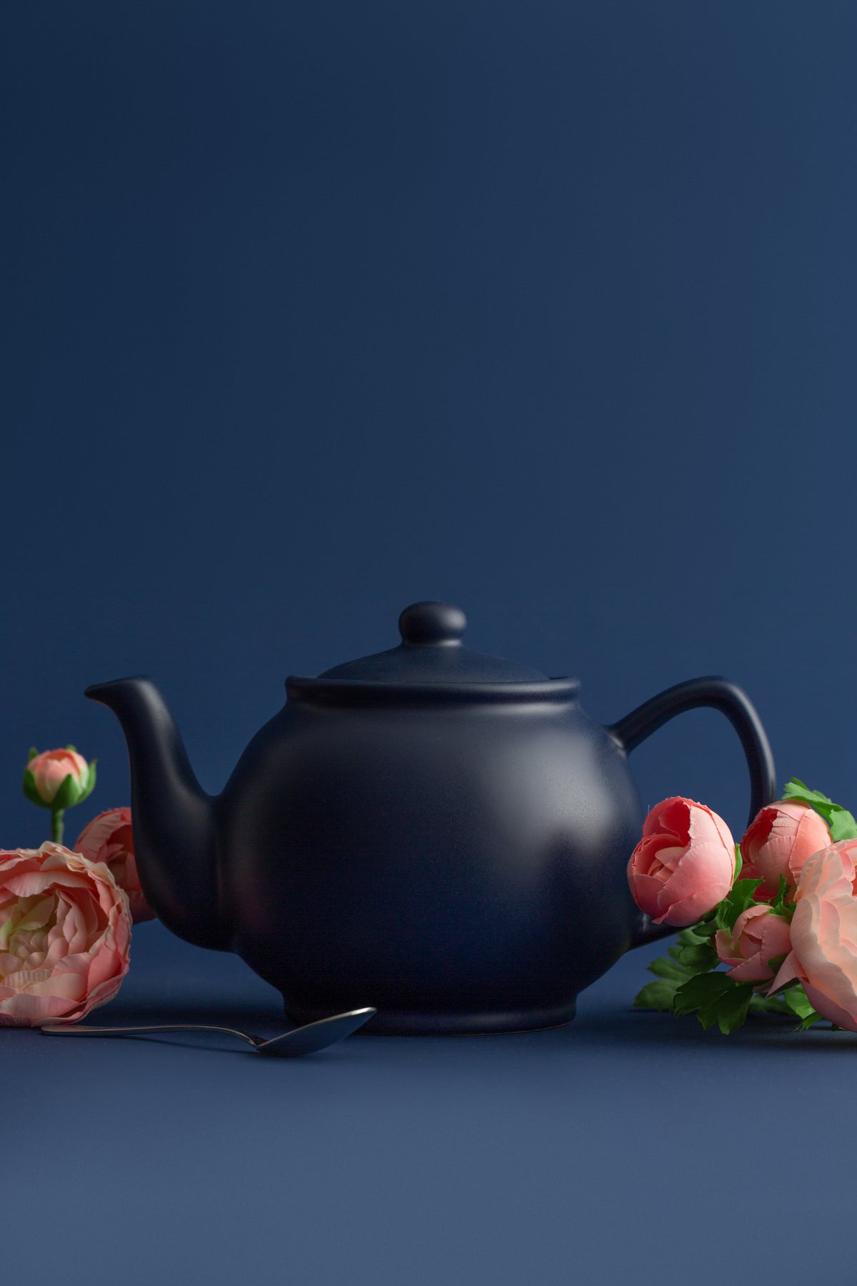 Blue P & K Kensington teapot with a smooth, rounded design and a curved handle, showcasing a stylish tea brewing vessel.