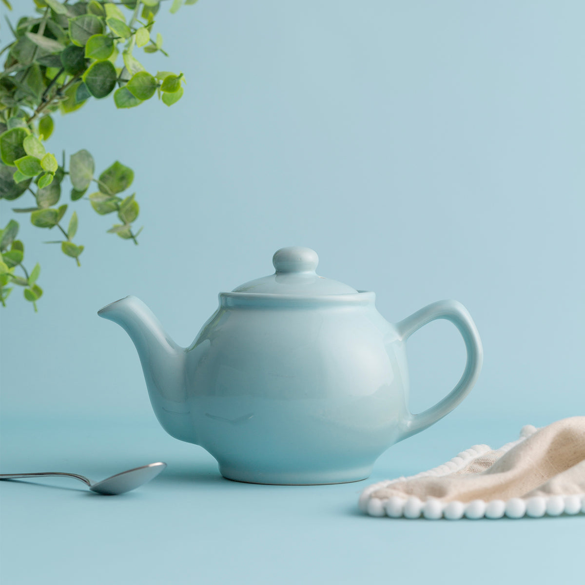 Blue P & K Price & Kensington teapot with two matching cups displayed on a white background.
