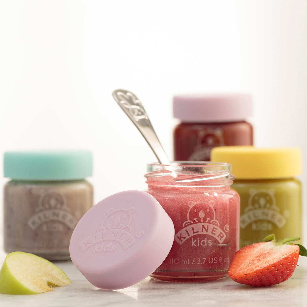 KILNER baby glass jars in clear and colorful designs, ideal for storing baby food or snacks, with playful patterns.