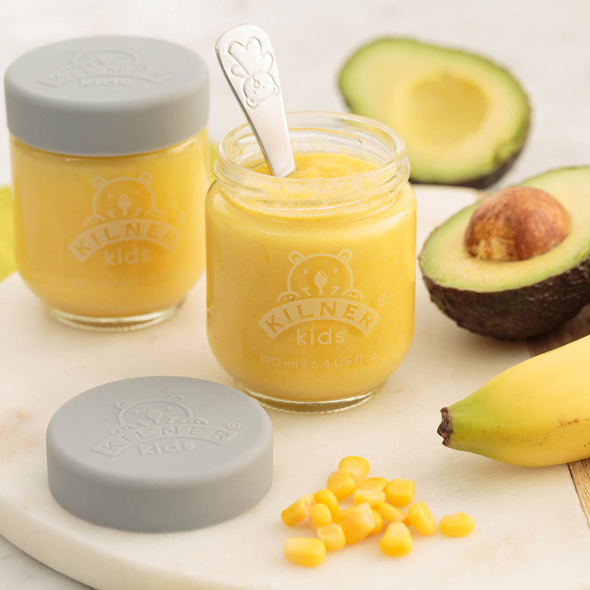 KILNER Babygläser set featuring clear and colorful glass jars for storing baby food or snacks, with vibrant lid designs.
