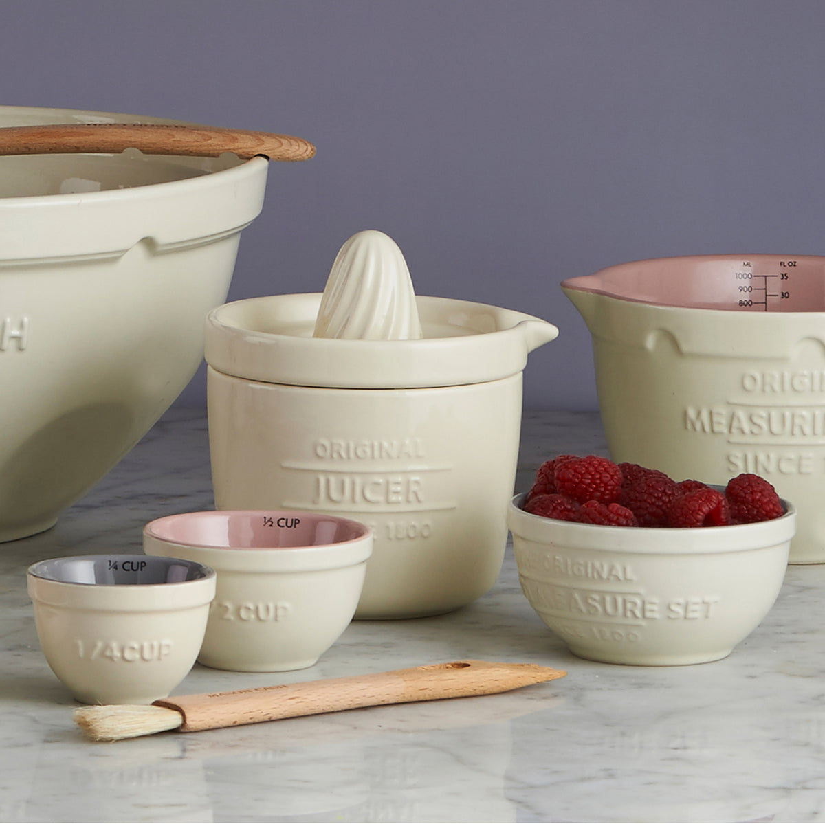 Mason Cash 4-piece white measuring cup set with clear measurements and sturdy handles for precise kitchen measuring.