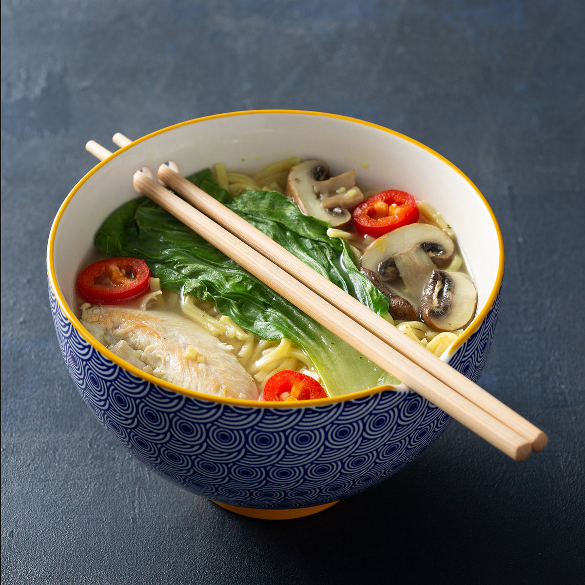 Blue TYPHOON noodle bowl with chopsticks, Asian style, round shape, with diameter specified in product details.