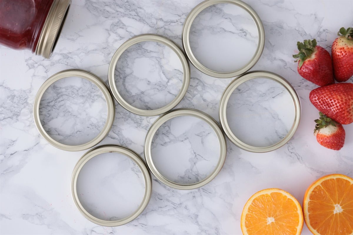 KILNER replacement parts for canning jars, including lids and seals, in a close-up image showing various jar components.