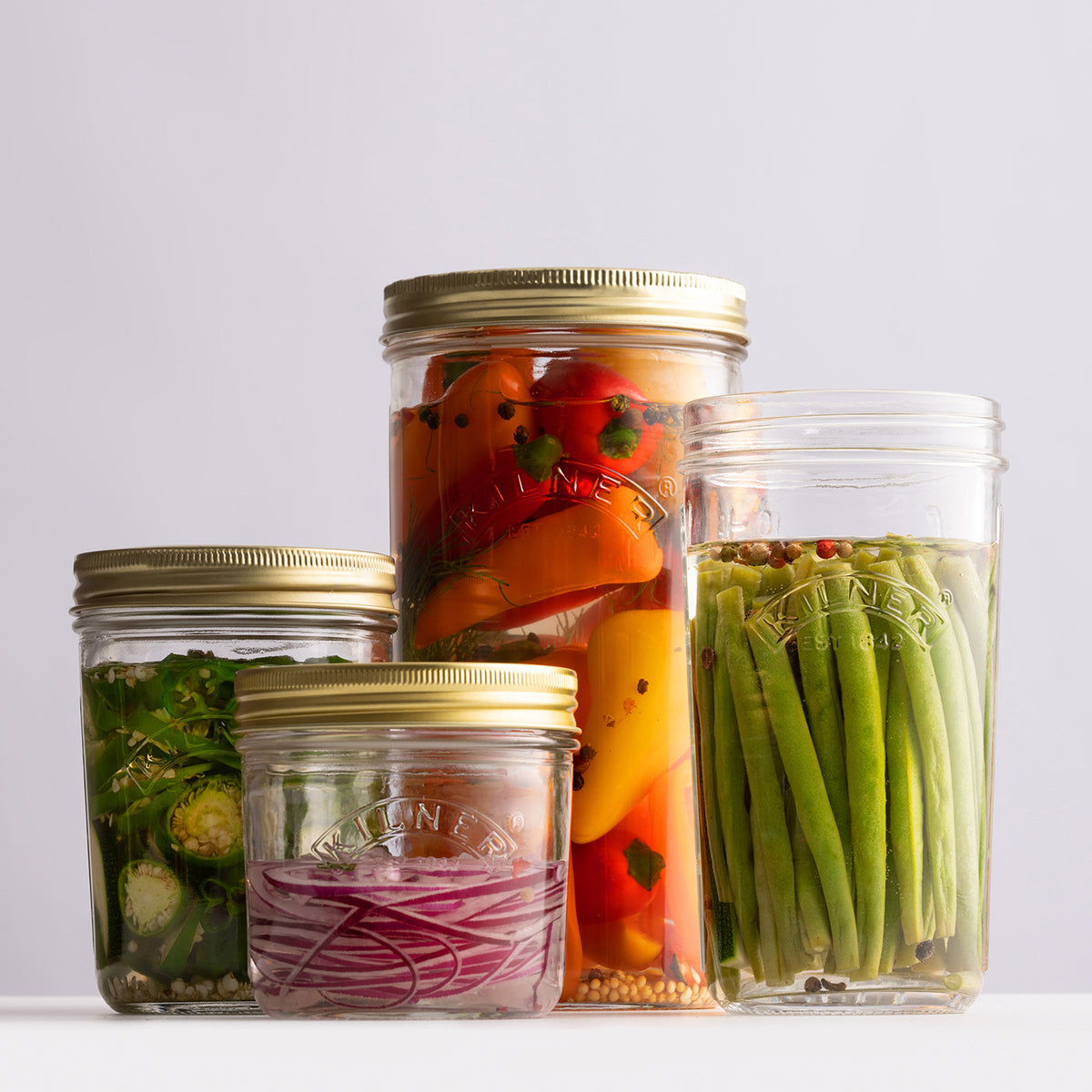 KILNER clear wide-mouth canning jar with metal lid for preserving fruits and jams, made of durable glass.