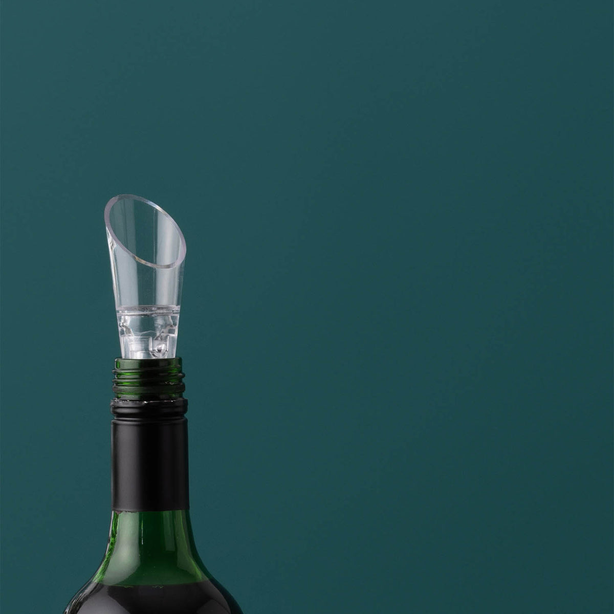 Clear VINERS wine aerator pouring wine into a glass, showcasing its sleek design and transparent construction.